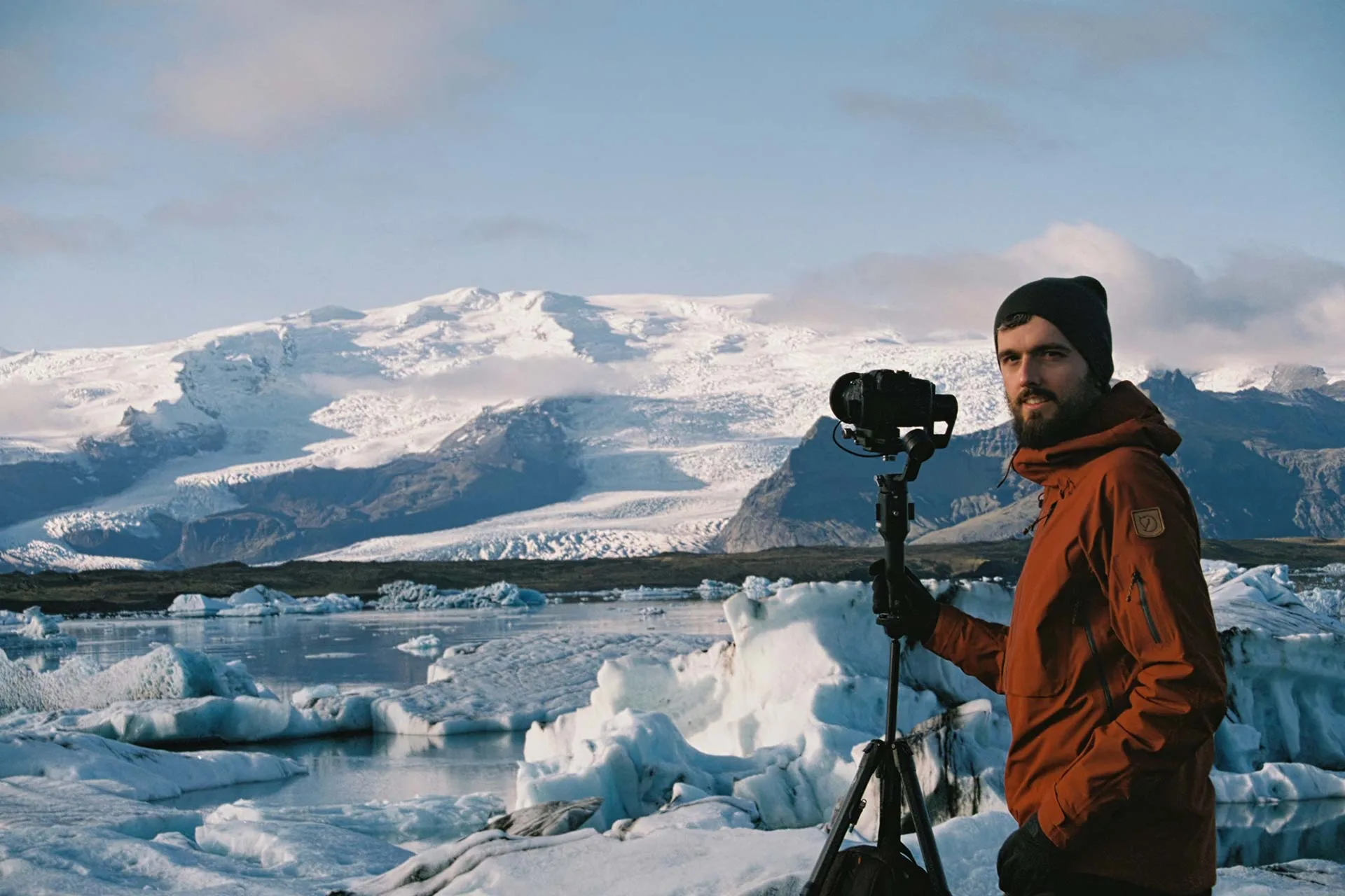 Filming at a glacier lagoon full of icebergs, with the camera on a tripod